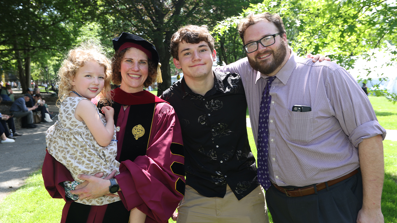 GSAS grad Claire Koen with her family in front of trees