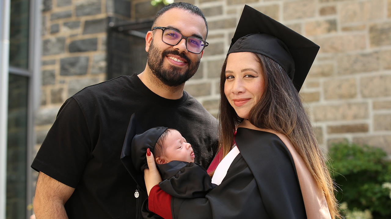 Gabelli graduate Liz Merida posing with partner and baby