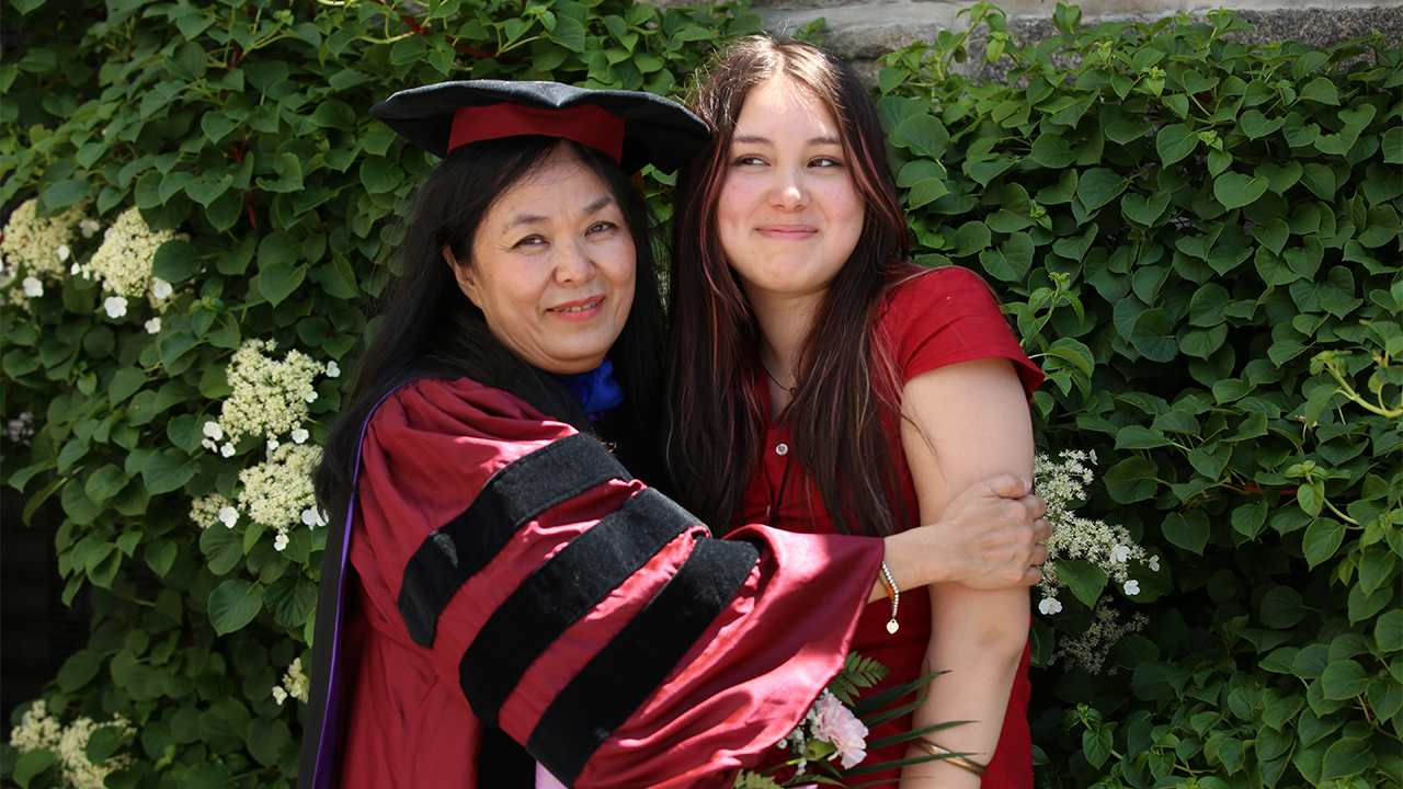 Mina Nguyen-Pepper posing with her daughter in front of vines