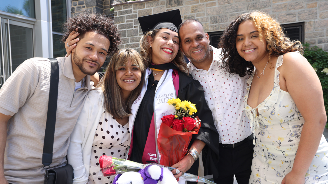 Veronica Pou posing with her husband and three children at Commencement