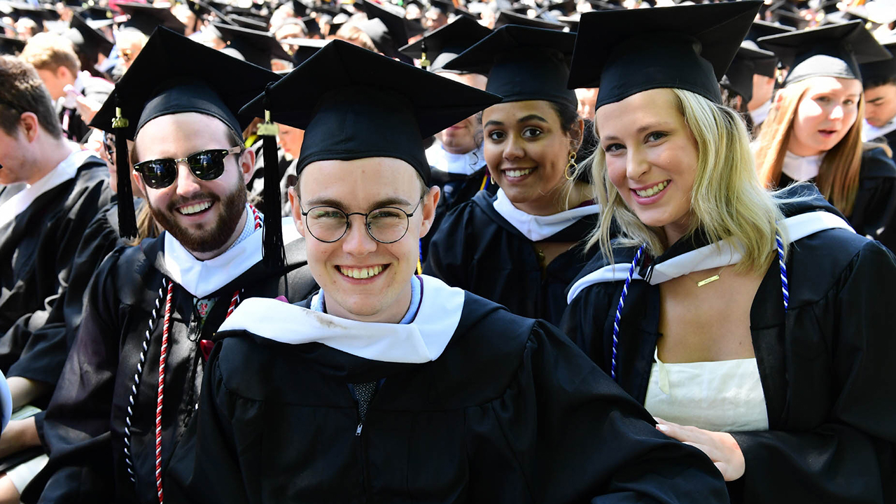 A group of graduates smiling at Rose Hill