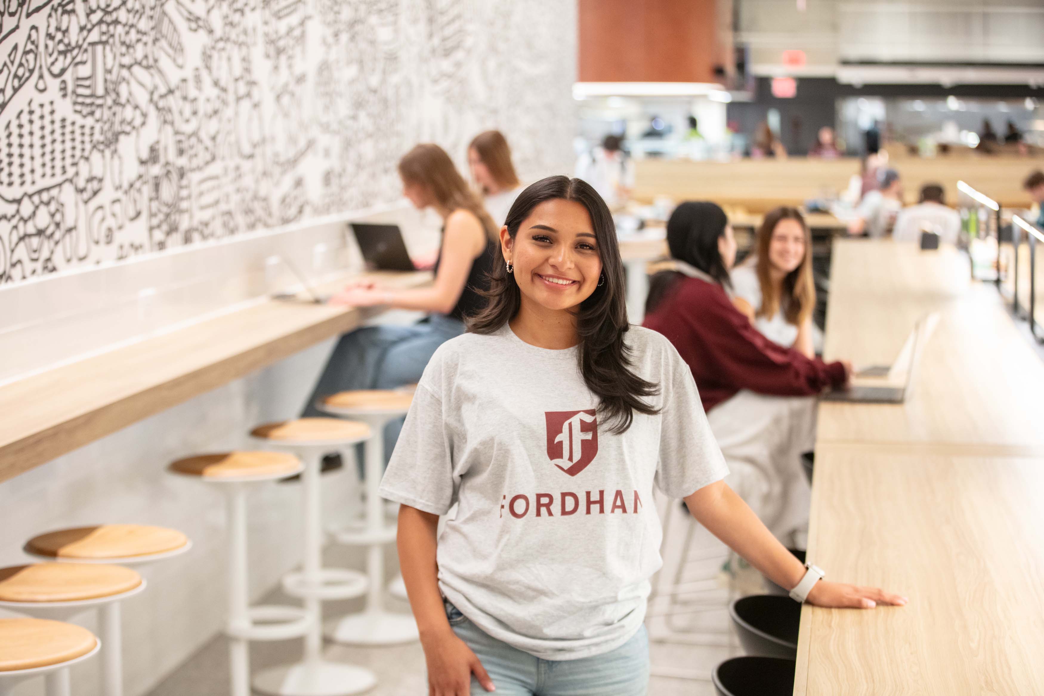 Female student with Fordham shirt in the marketplace