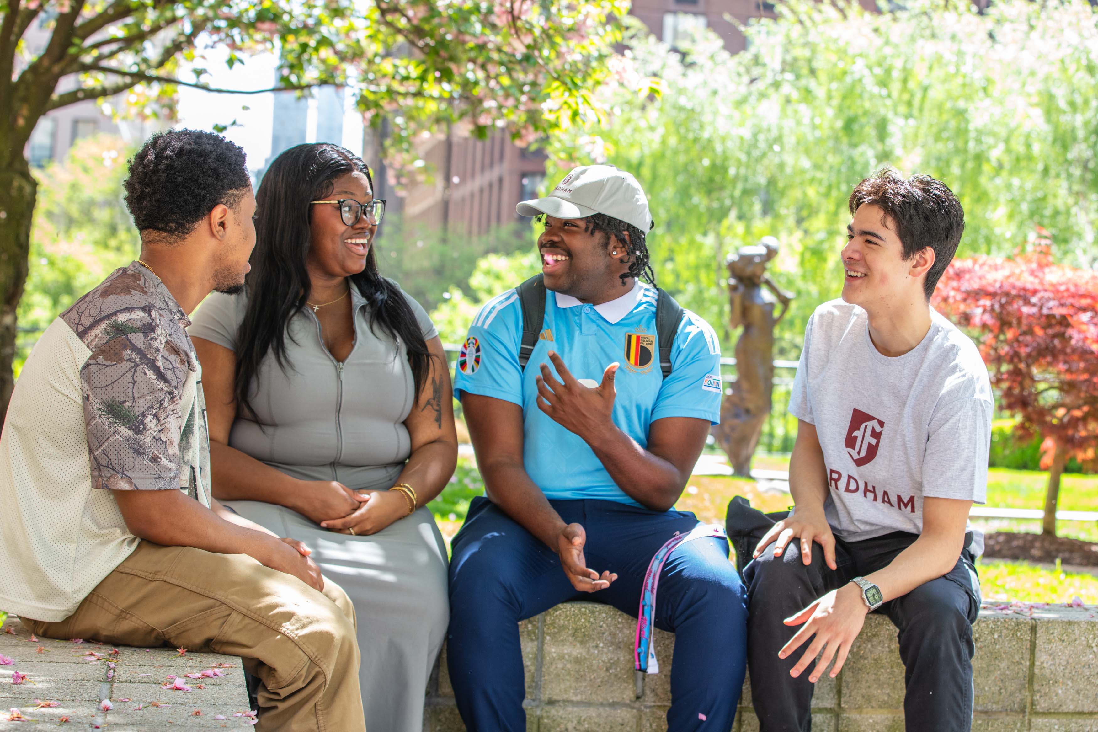 four students sitting and talking at Lincoln Center campus