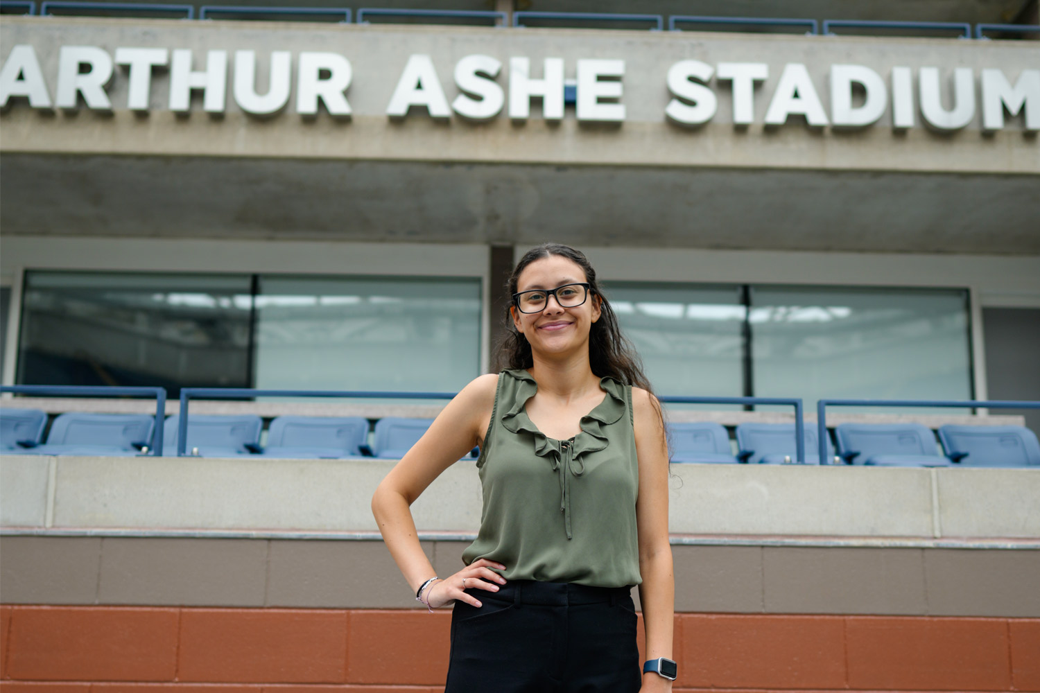 Bianca Ortega stands inside the Arthur Ashe Stadium in Queens, N.Y.