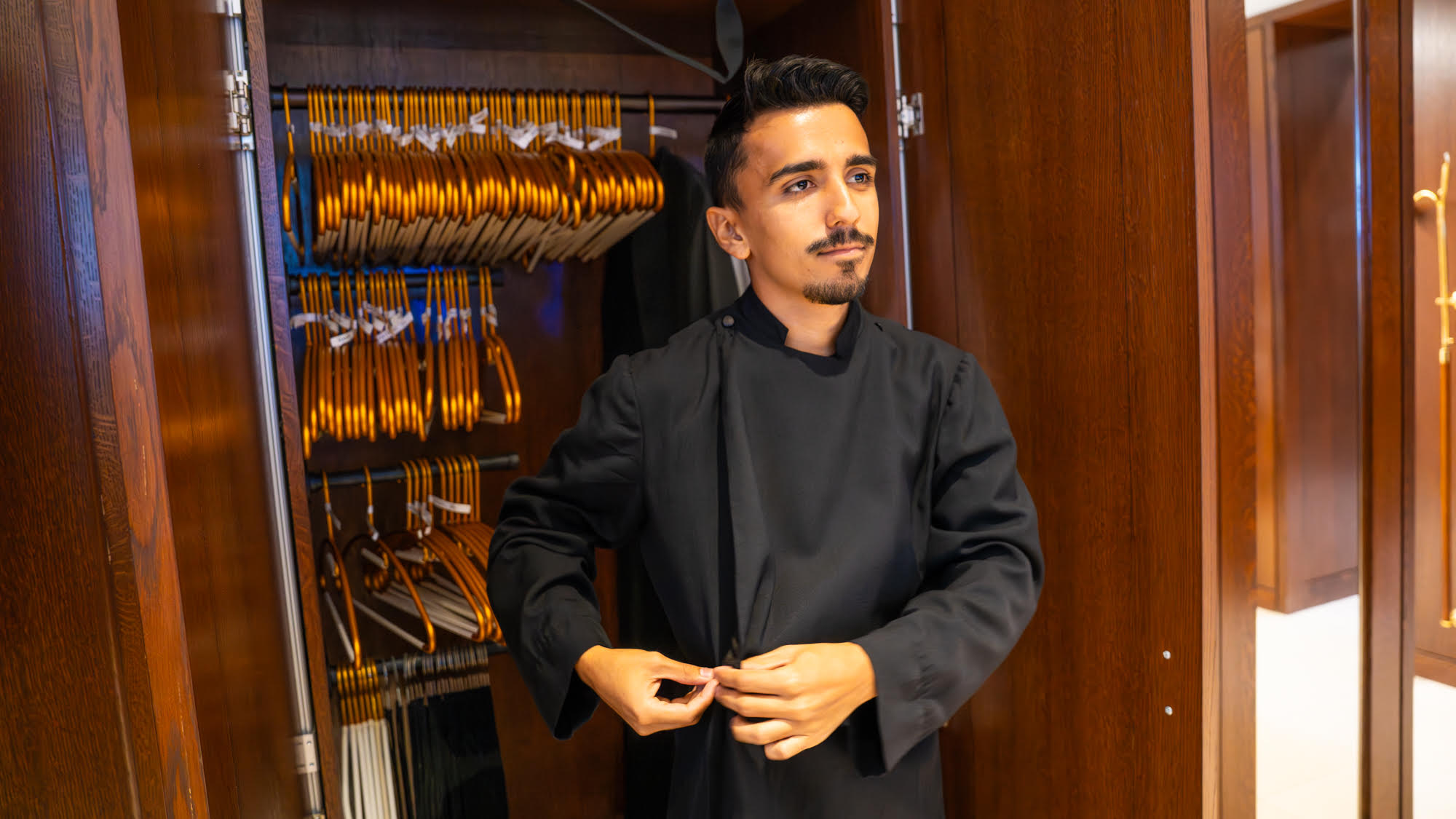 John Garza dresses in vestments for service at Trinity Church