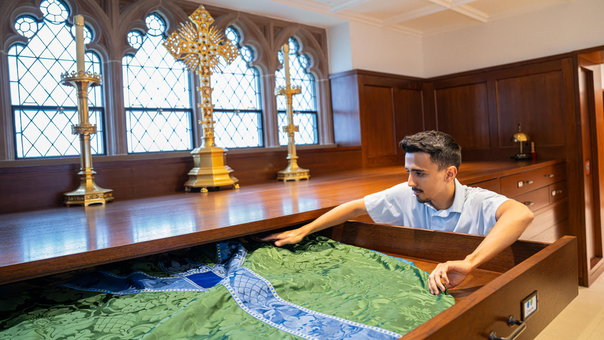 John Garza prepares clergy vestments for mass at Trinity Church