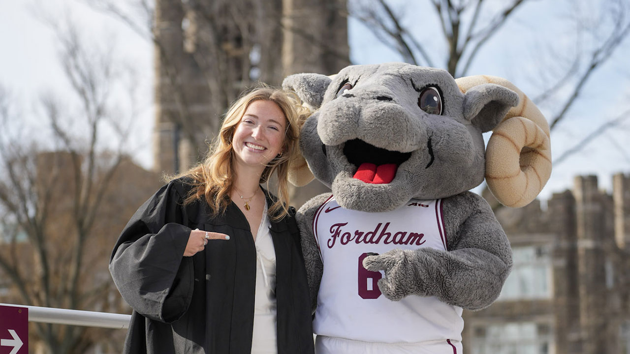 Abby Hartlieb poses in graduation portrait with Ramses