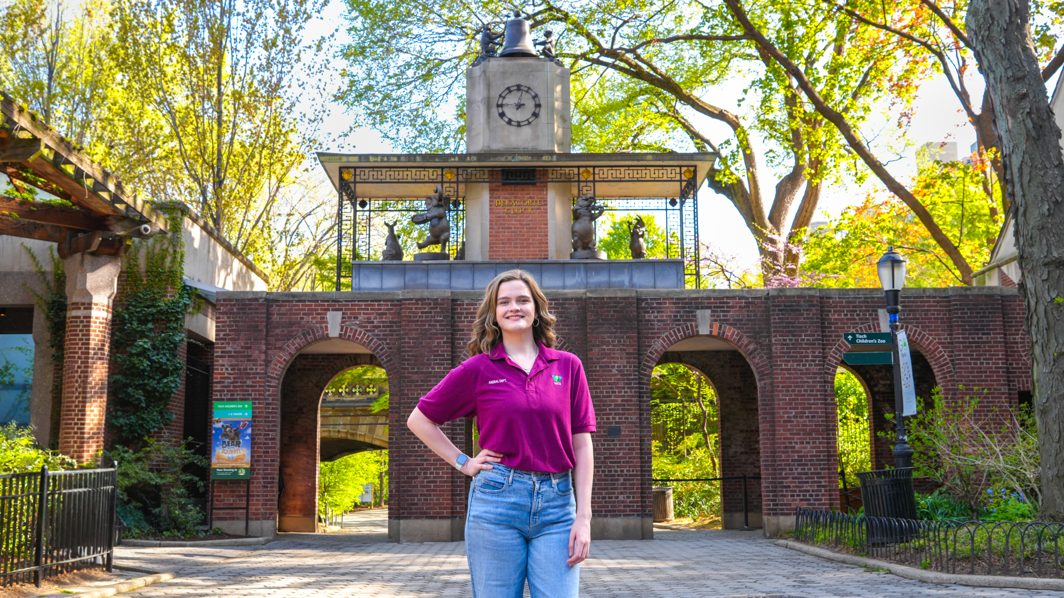 Shannon smiles in front of a big clock.