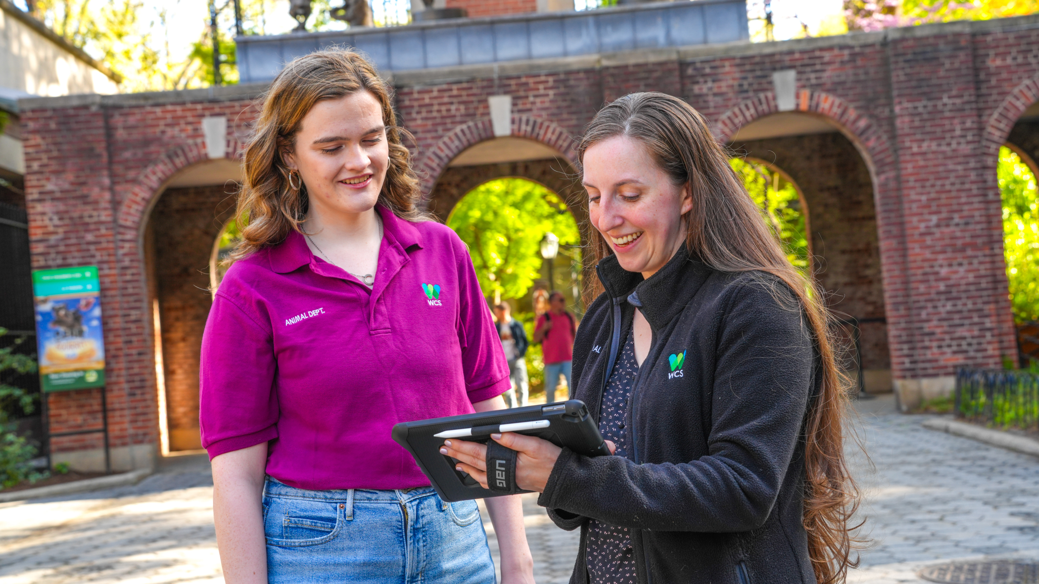 Shannon and her supervisor observe data on an iPad.