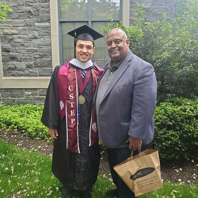 Daniel Hart posing with his father on graduation day