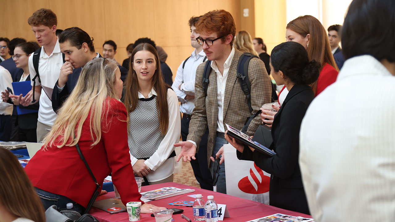 Students talk to a recruiter at an internship fair at Fordham's Rose Hill campus.