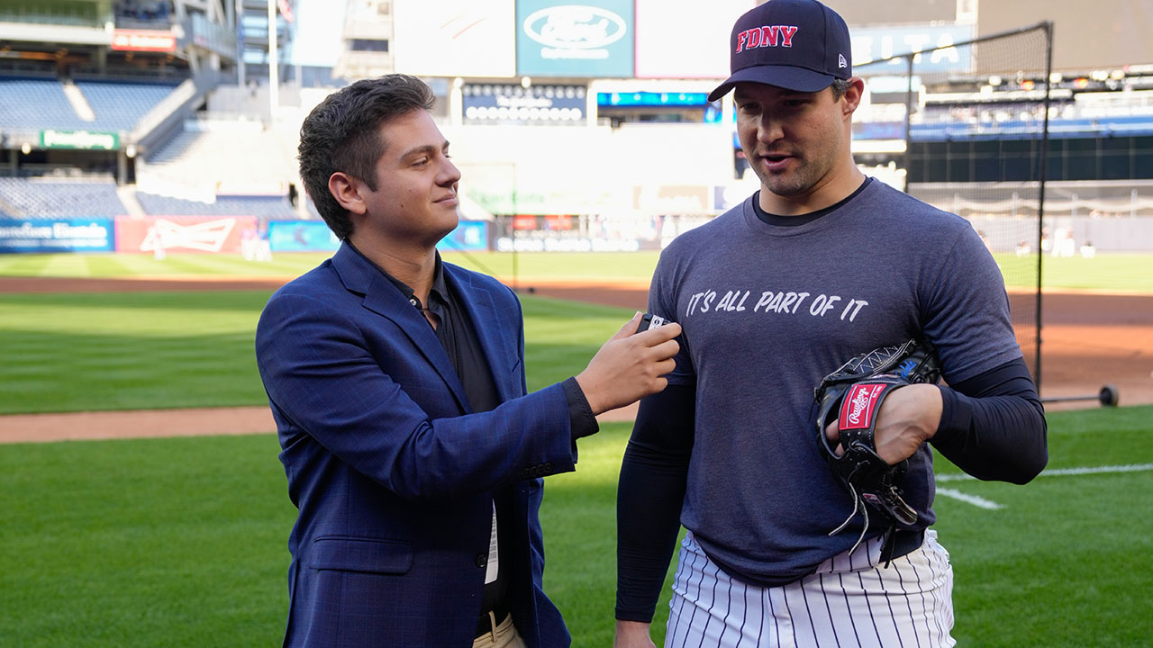 A WFUV sports reporter interviews a Yankee player