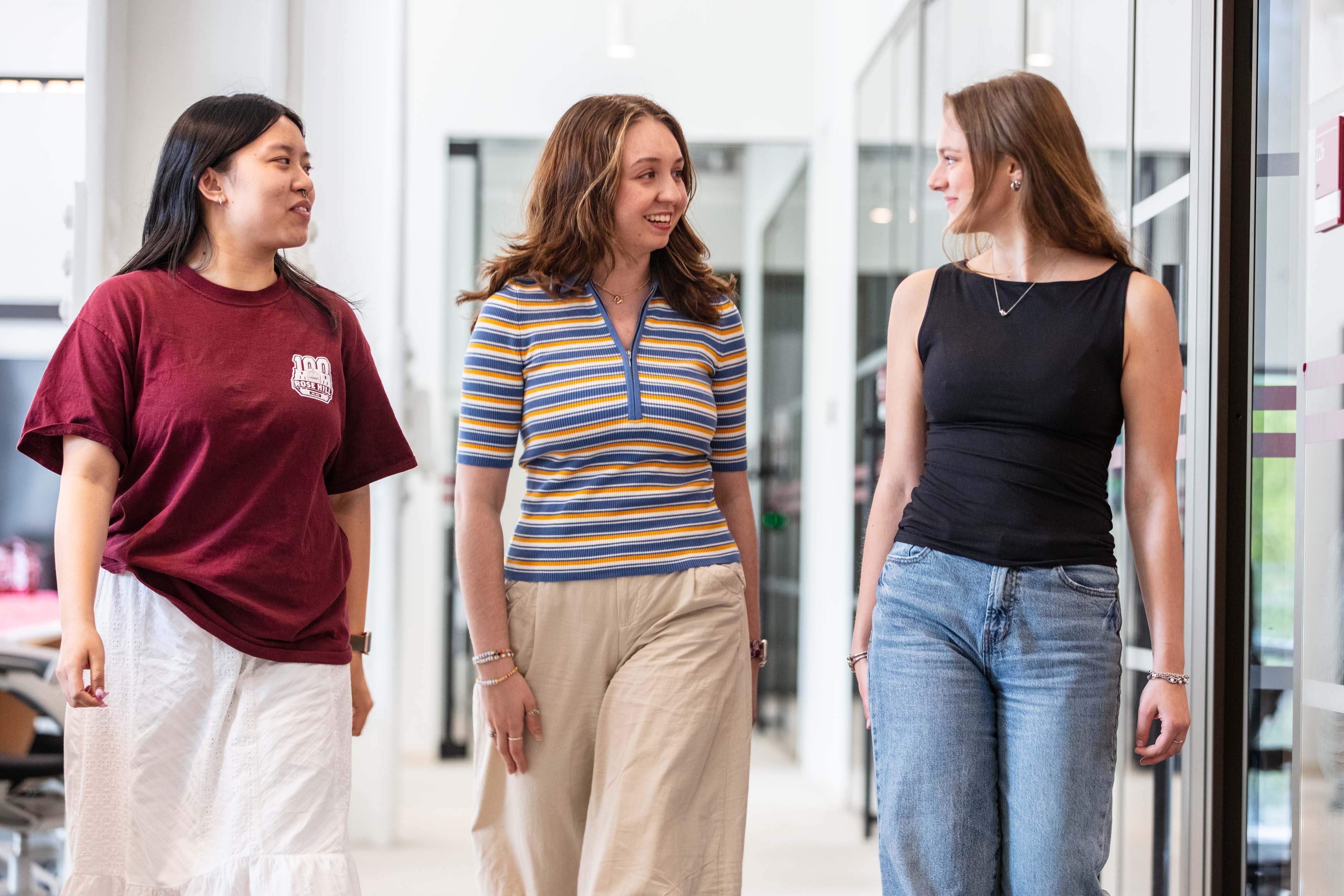 three females walking and talking