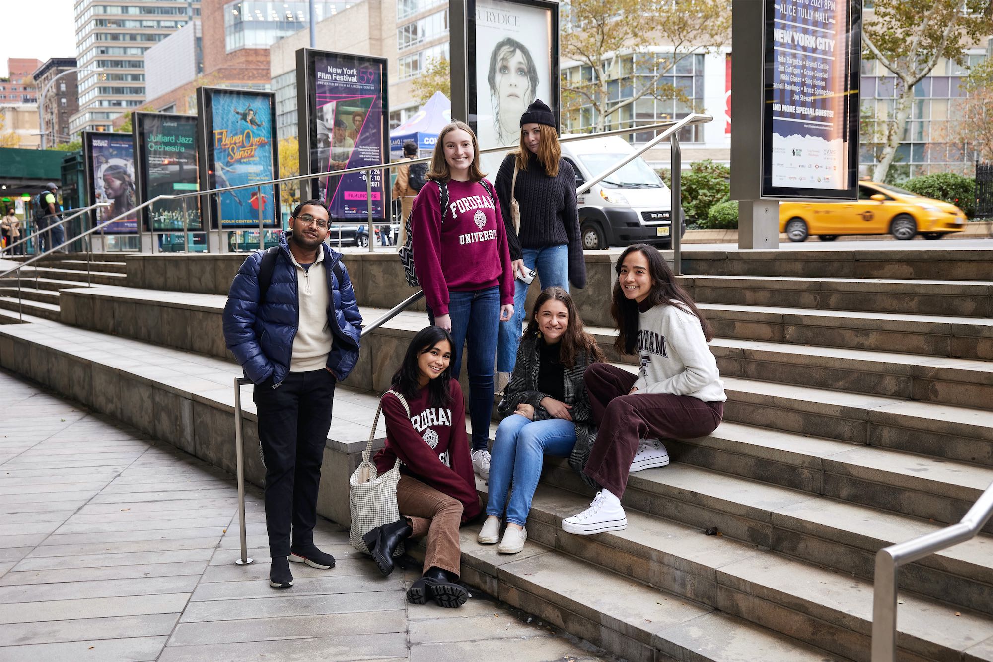 Students sitting and standing on steps