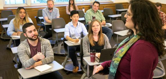 Students interacting with professor in classroom