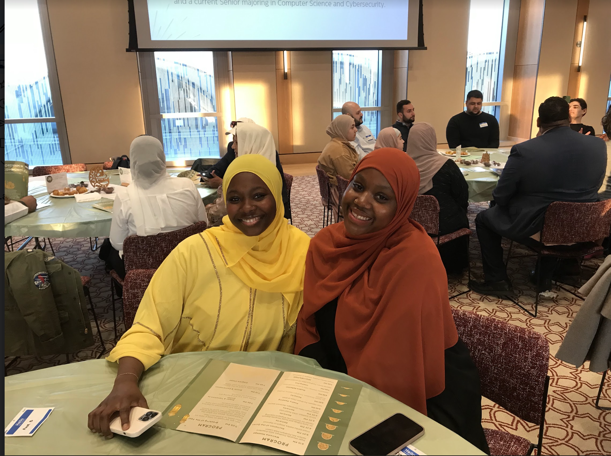 two muslims students wearing a turban smiling