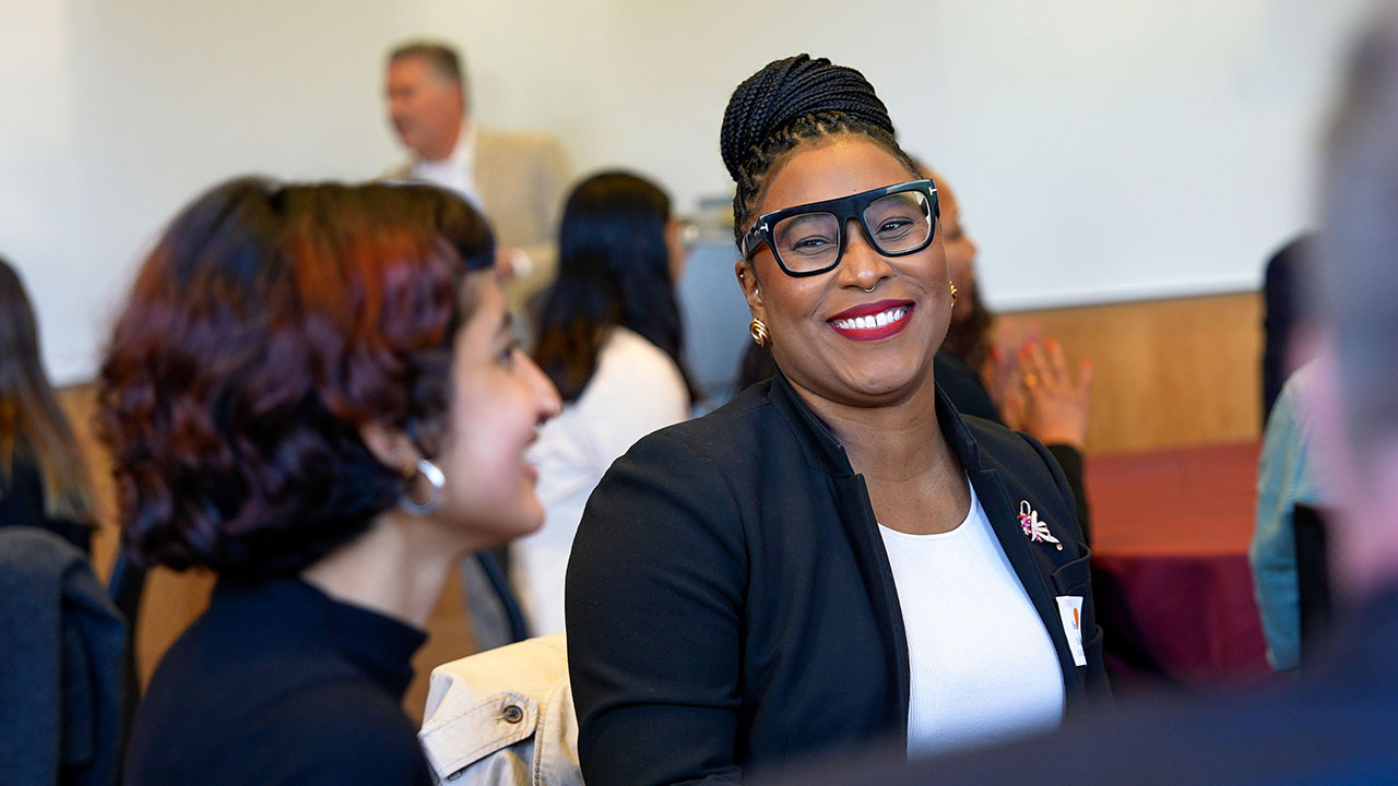 two young women talking and smiling