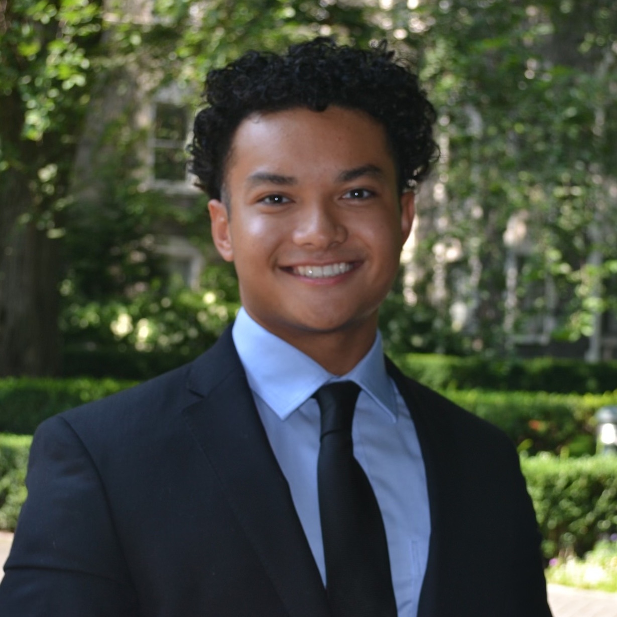 Benjamin smiling wearing a suit