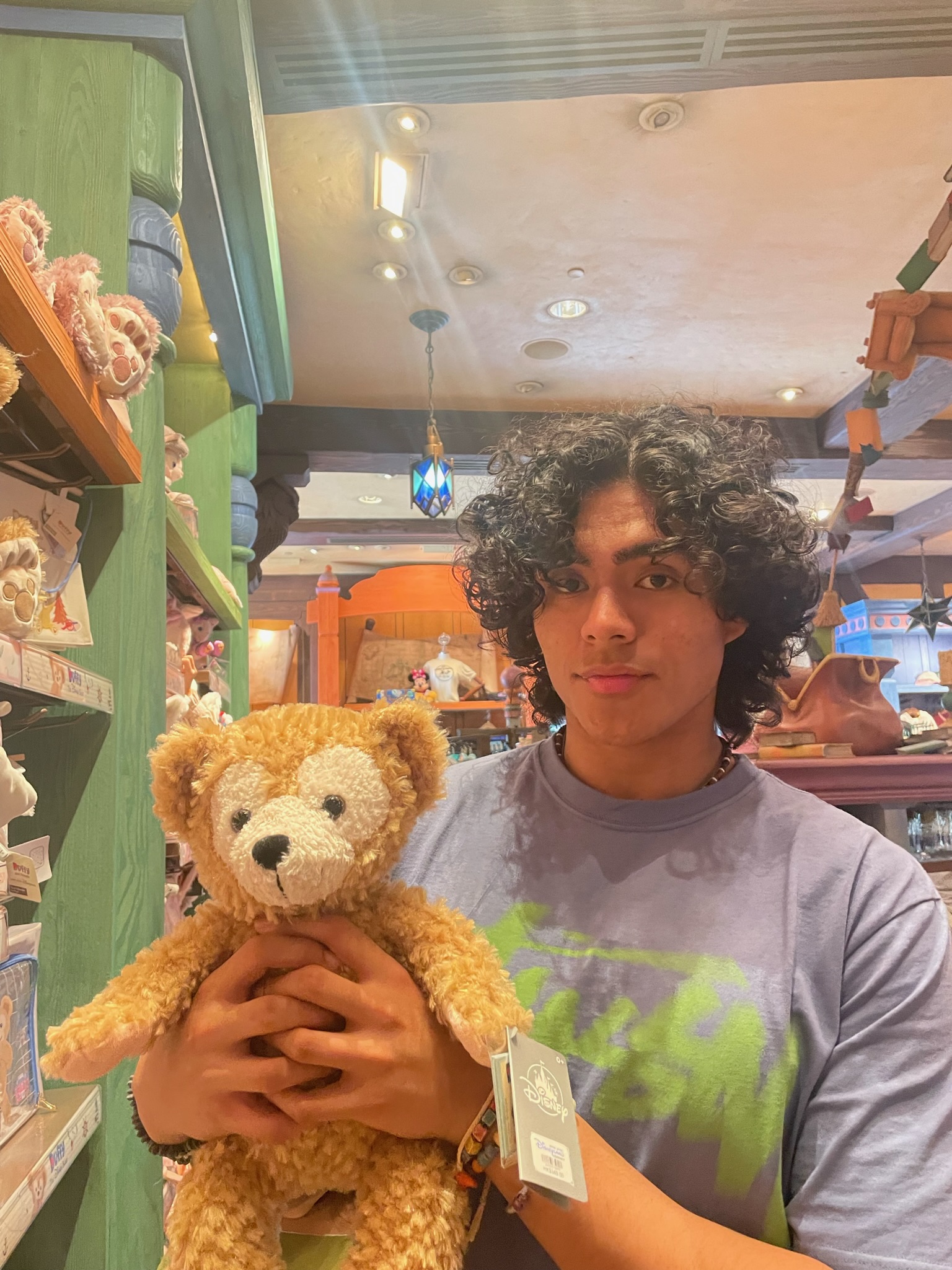 Student in a store holding a teddy bear