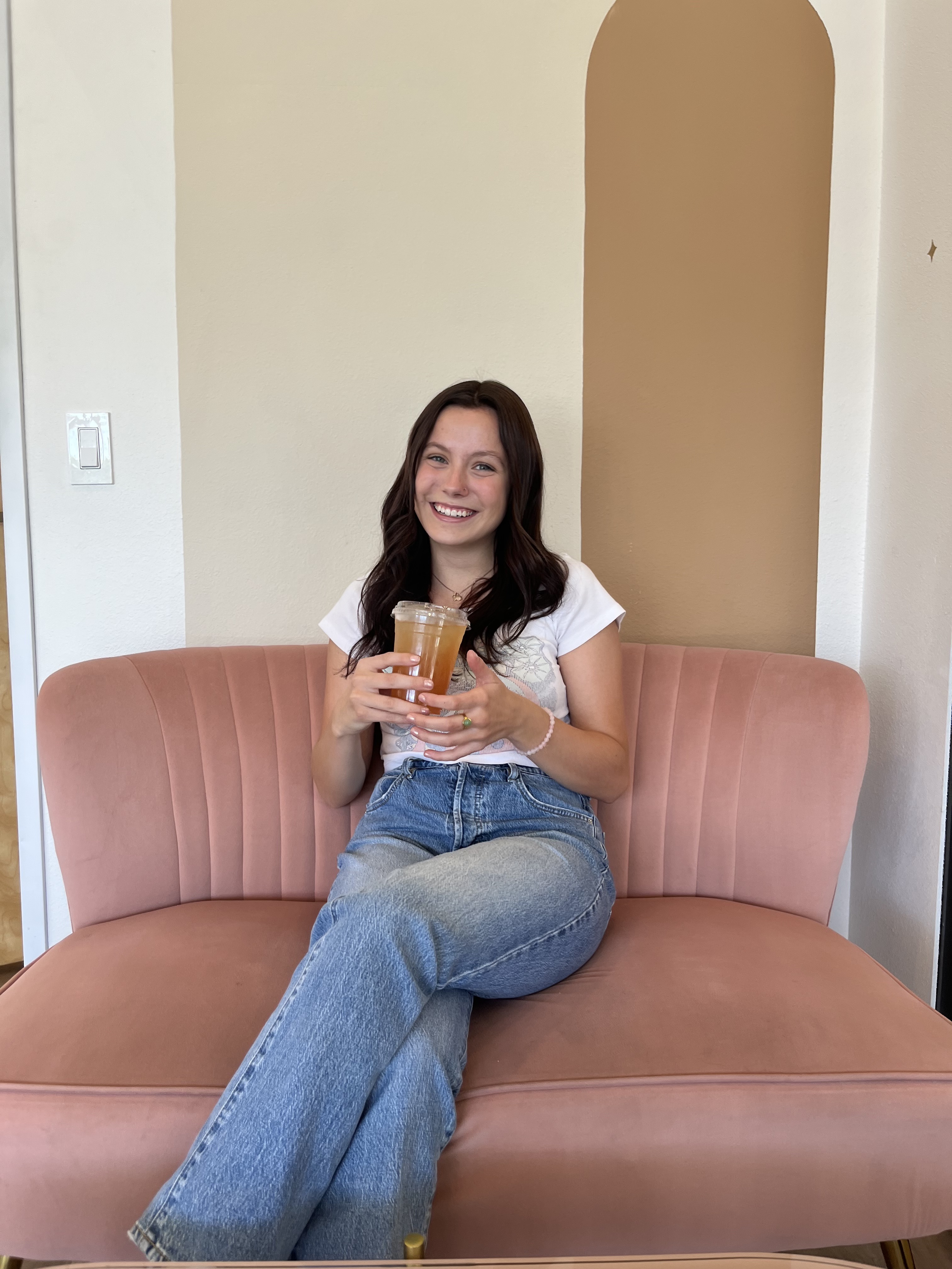 Student sitting on a pink chair