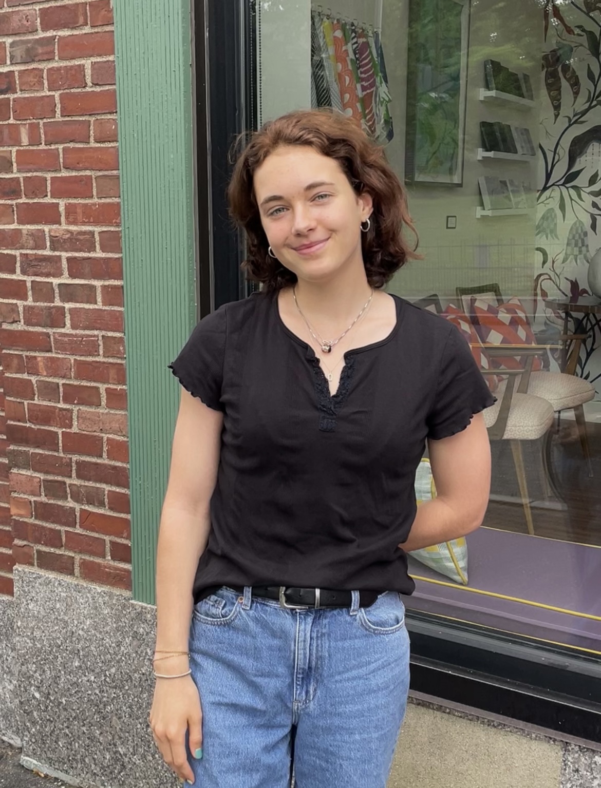 Student standing in front of a store