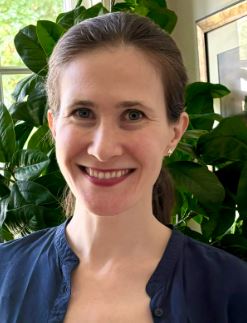 A headshot photo of Allison Cryer, a doctoral student in the biblical studies track in the Theology Department at Fordham University. Allison is wearing a blue shirt.