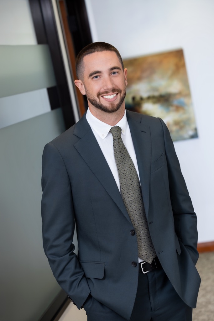 Young man with beard in a suit and tie.