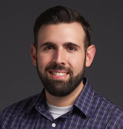 Young man with brown hair and beard.