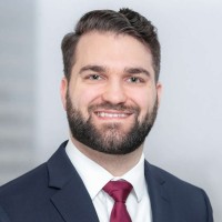 Young man with beard in a suit and tie.