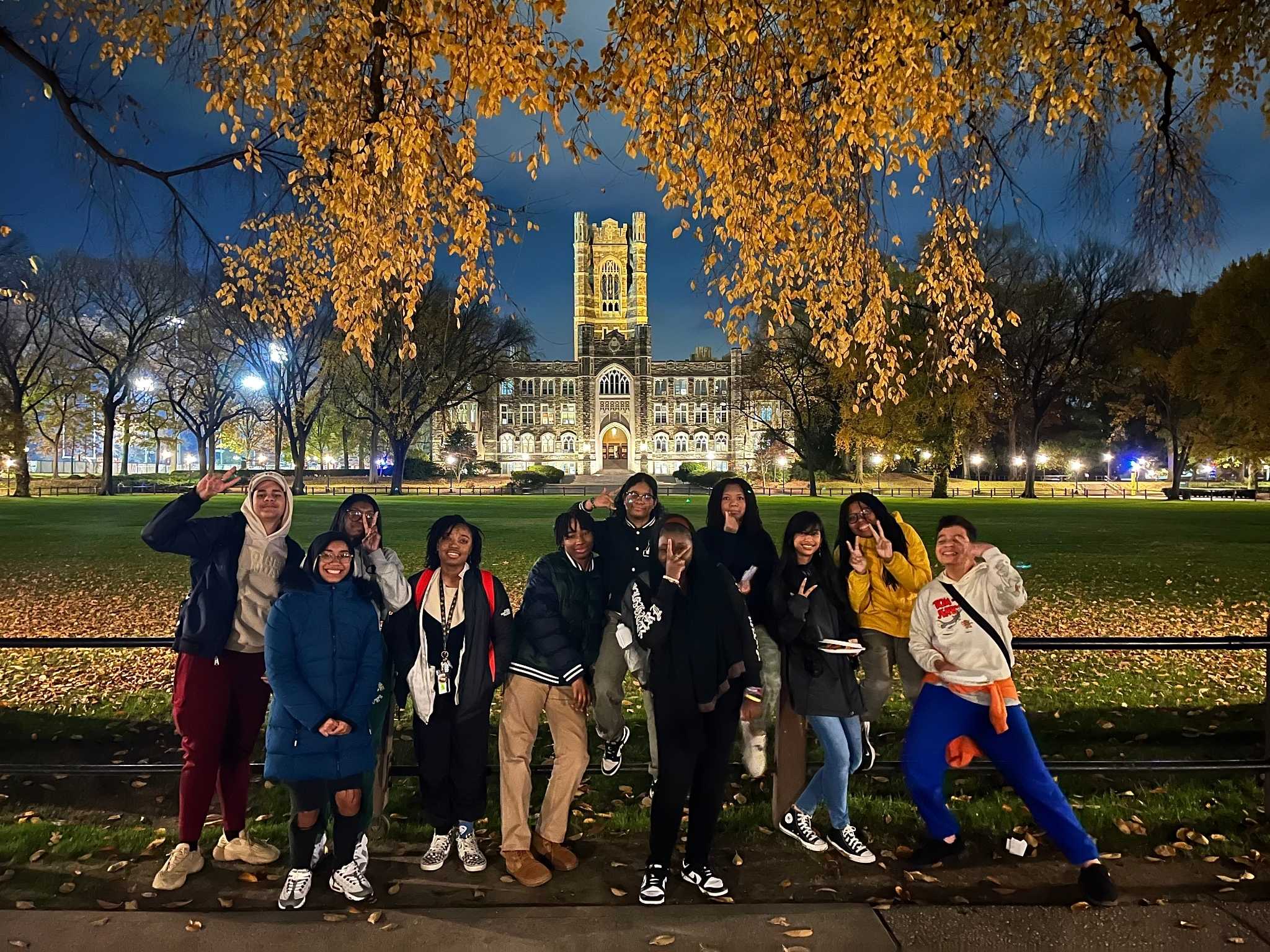 group of students gathered and smiling with Keating Hall in the background