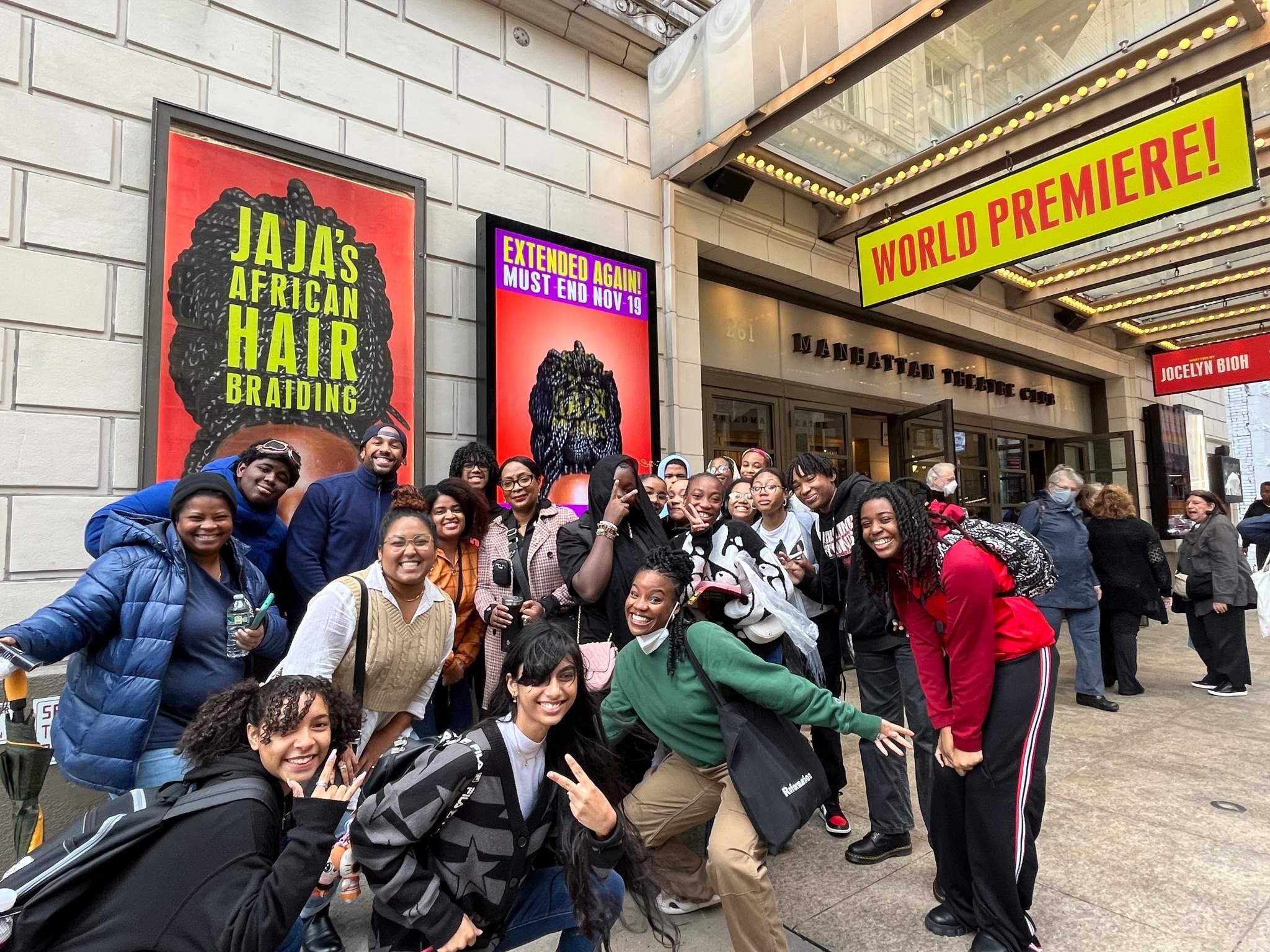 school students gathered around a broadway playhouse