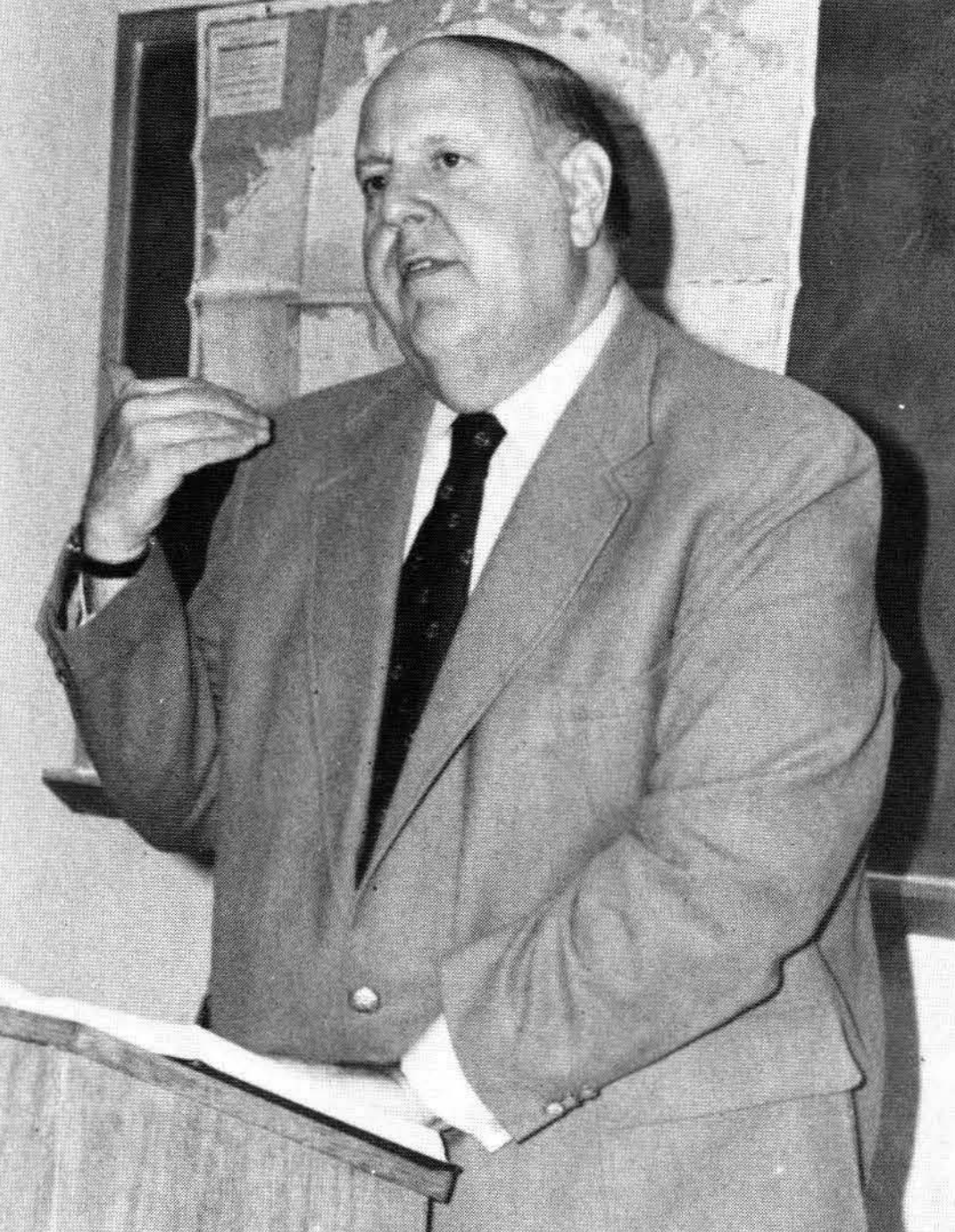 Fordham Law Professor Joseph Sweeney 1981 in front of map at podium