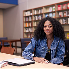 Student sitting at desk in library